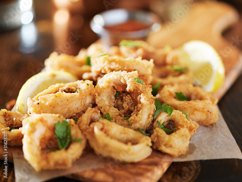 crispy fried calamari rings wih marinara dipping sauce and lemon
