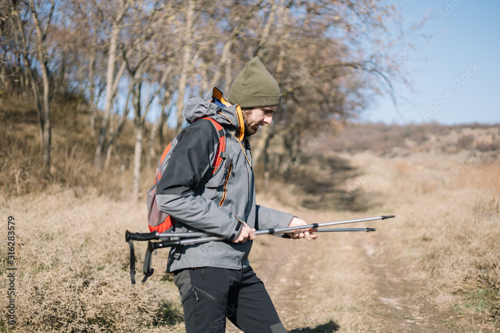 Young man with hiking equipment looking front Young man with hiking equipment looking front