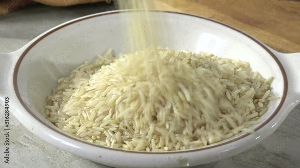 Pouring rice into a small bowl 