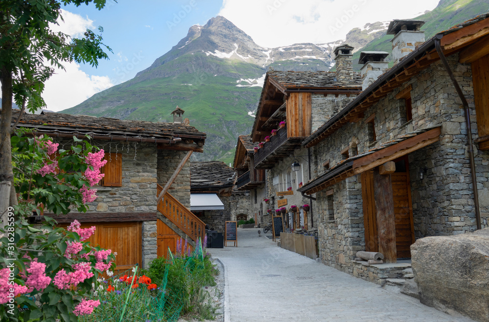 CLOSE UP: Empty asphalt streets run through the medieval town in the French Alps
