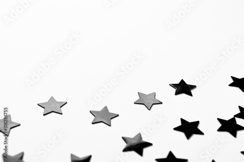 Black shiny stars on white background