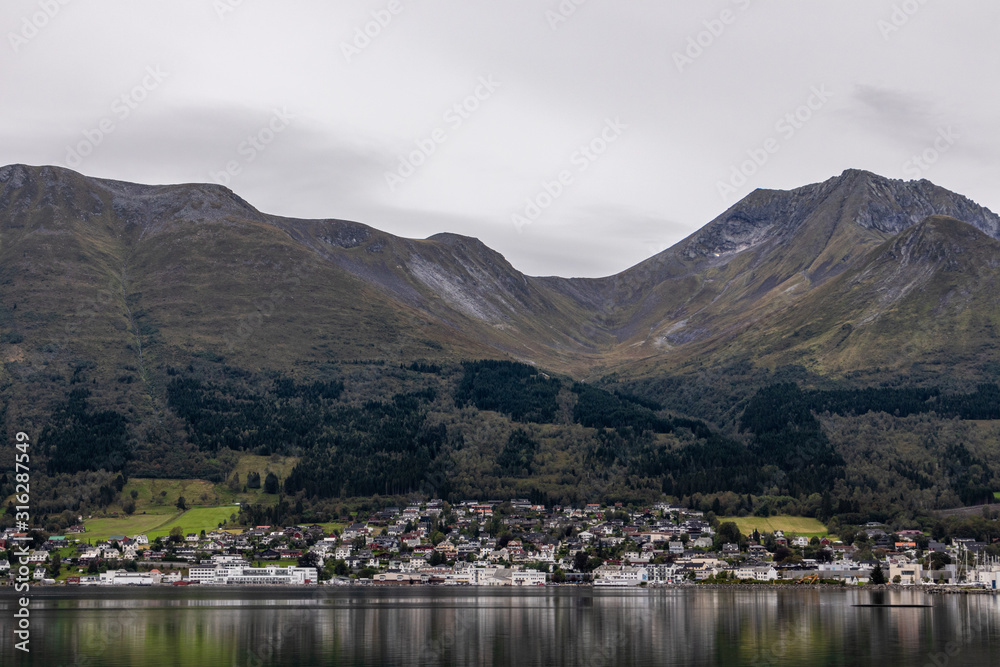 Cloudy day in Norway mountains town, lake nature 
