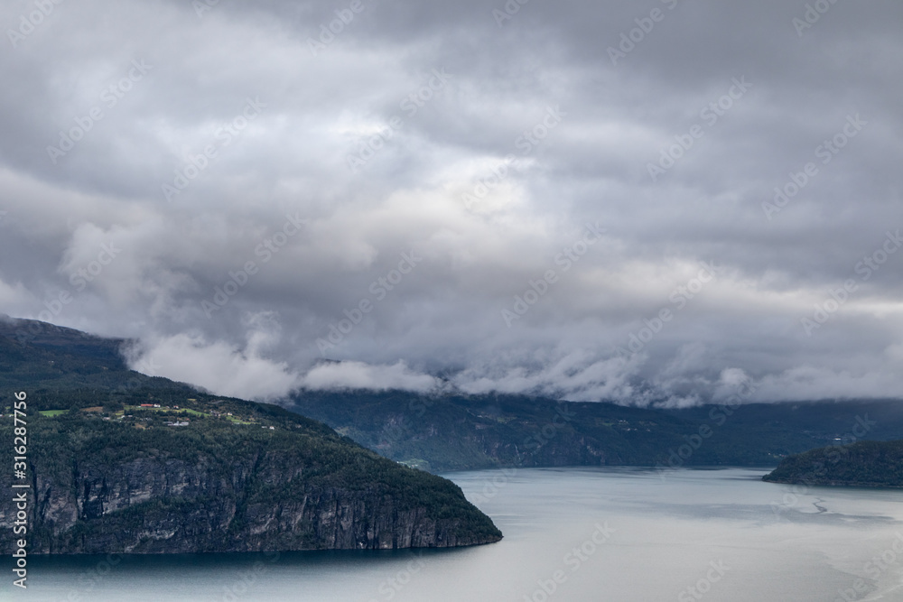 Cold grey color Norway landscape on fjord coast 