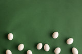 White hen eggs on dark olive green background