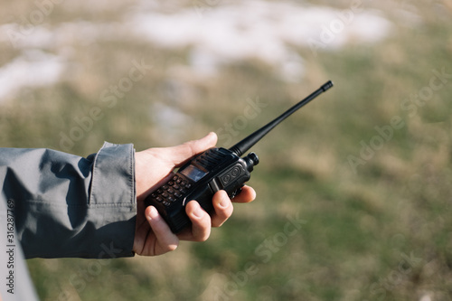 Close-up of a mans hand holding GMRS radio