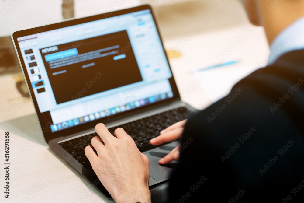 The office man typing something on white computer keyboard in office The office man typing something on white computer keyboard in office