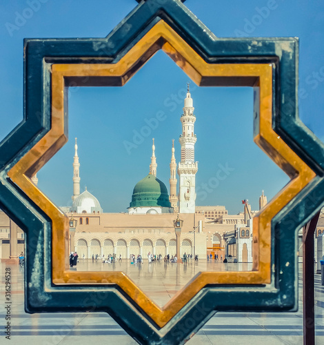 Vintage tone filter of exterior view of minarets and green dome of Nabawi mosque, Medina  Saudi Arabia taken off the compound.