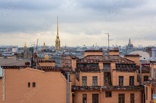 Beautiful top view of the historic city center of St. Petersburg. Cityscape with roofs of buildings and a high bell tower of the Peter and Paul Cathedral with a golden spire. Saint-Petersburg, Russia. © Andrei Stepanov