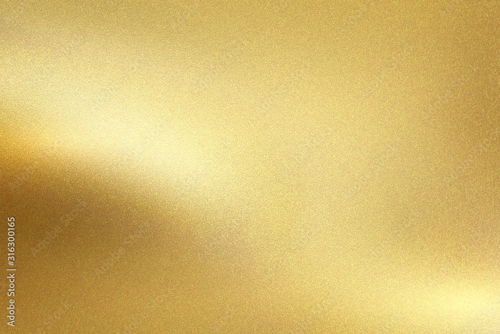 Gold foil metal wall with glowing shiny light, abstract texture background Gold foil metal wall with glowing shiny light, abstract texture background