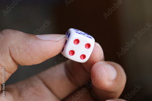 Hold the white dice with your hands to show and play