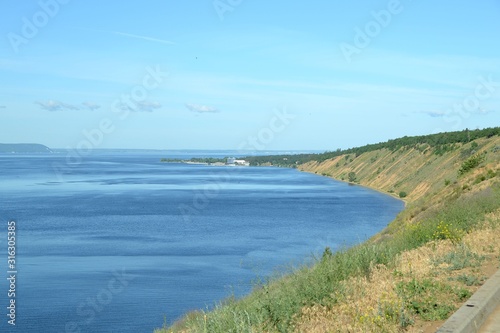 River waters jutting into the smooth curve of the high Bank