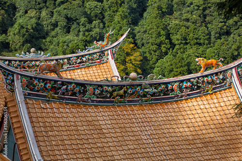 The colorfully decorated curved tile roofs of the abandoned  Chinese temple. Wakayama. Japan photo