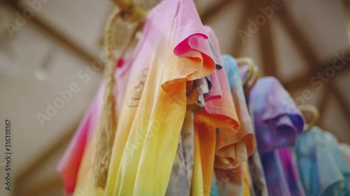 El Nido, Philippines - Vibrant Colored Dyed Shirts Hanged And Air Dried On A Wooden Clothesline - Close Up Shot photo