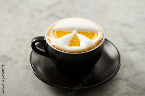 Cafe latte, latte art with orange 