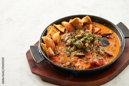 Grilled oyster with tomato sauce 
