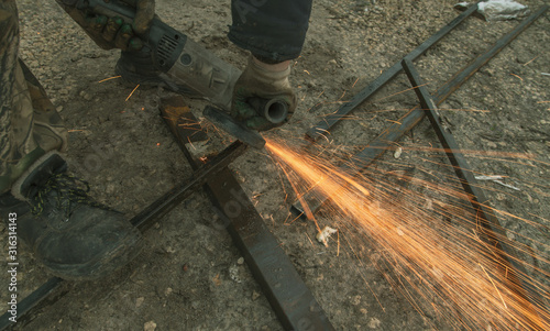 Sparks from sawing metal at a construction site