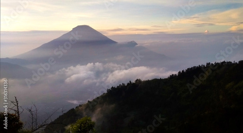 Foggy sunrise scenery of Mount Prau from Bukit Sikunir  Dieng Plateau.