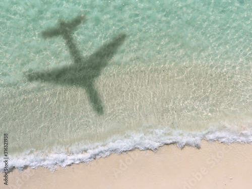 Shadow Of An Aero Plane Flying Over Beach