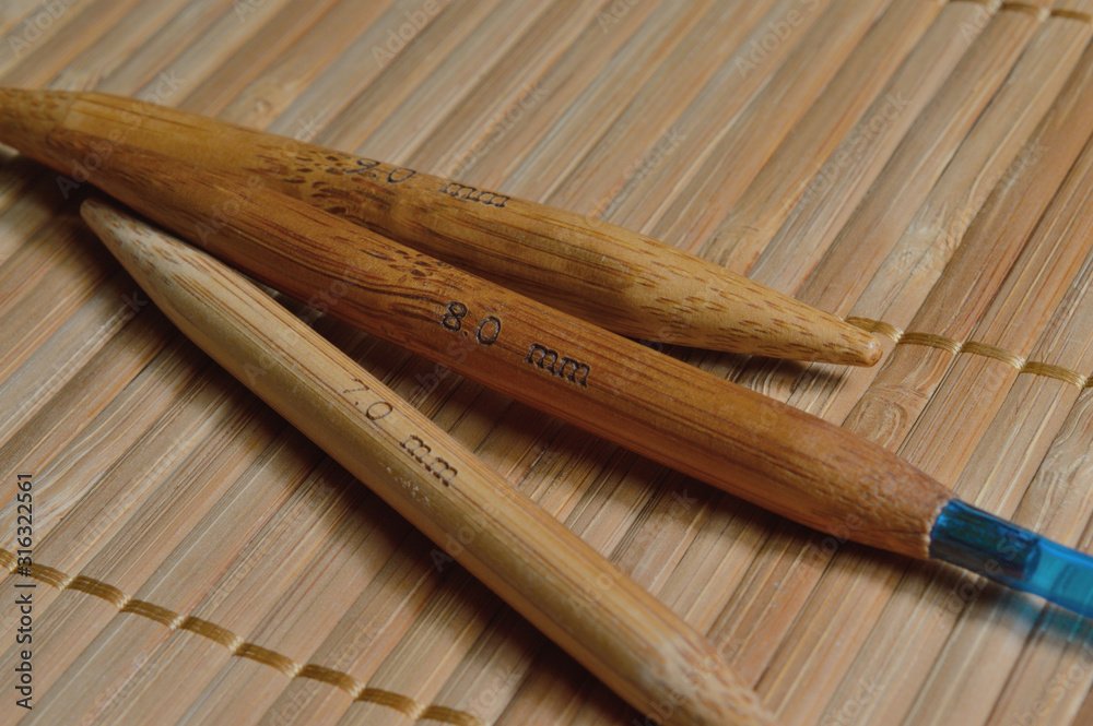 circular bamboo knitting needles on a wooden surface.
