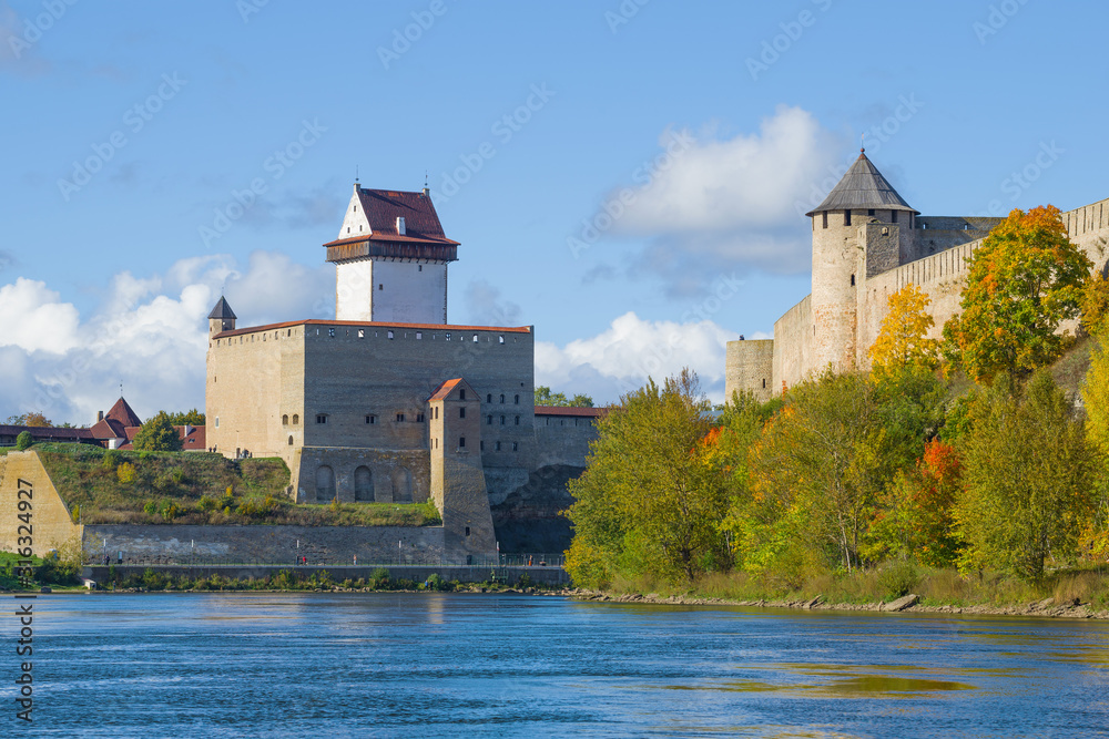 Estonian Herman castle at the Russian Ivangorod fortress in golden autumn. The border of Estonia and Russia