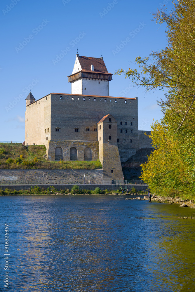 Old Herman Castle over the Narva River on a sunny September day. Estonia