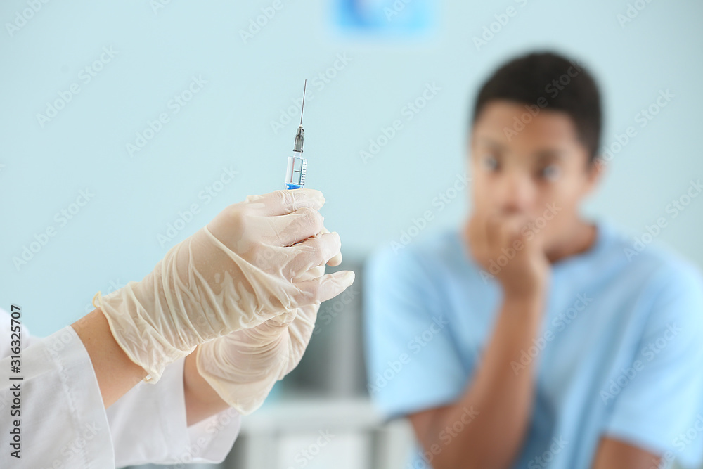 Doctor with vaccine in syringe prepared for injection in clinic Doctor with vaccine in syringe prepared for injection in clinic