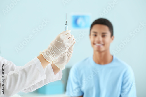 Doctor with vaccine in syri...