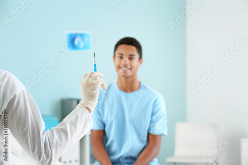 Doctor with vaccine in syri...