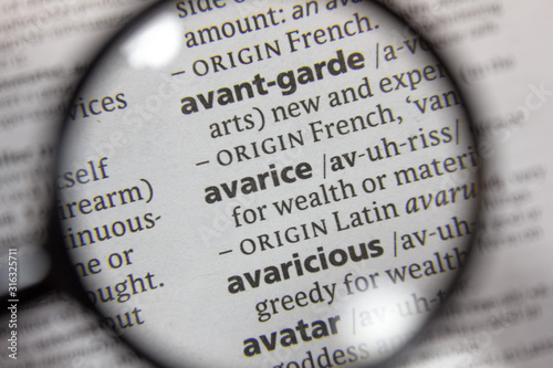 The word of phrase - avarice - in a dictionary. photo