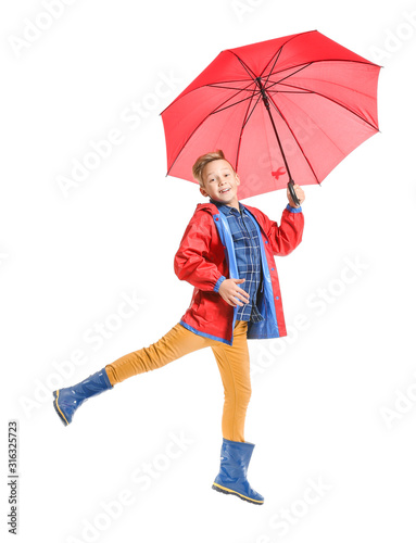 Jumping little boy with umb...