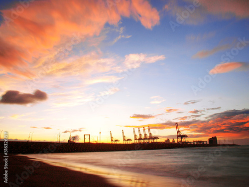 Sunset in seacoast near cargo wharf © marchcattle