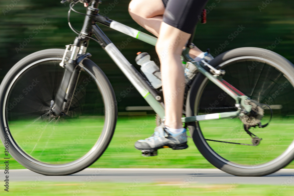 Fototapeta premium Riding bicycle - blurred motion, fast driving.