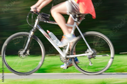 Fototapeta Naklejka Na Ścianę i Meble -  Riding bicycle - blurred motion, fast driving.