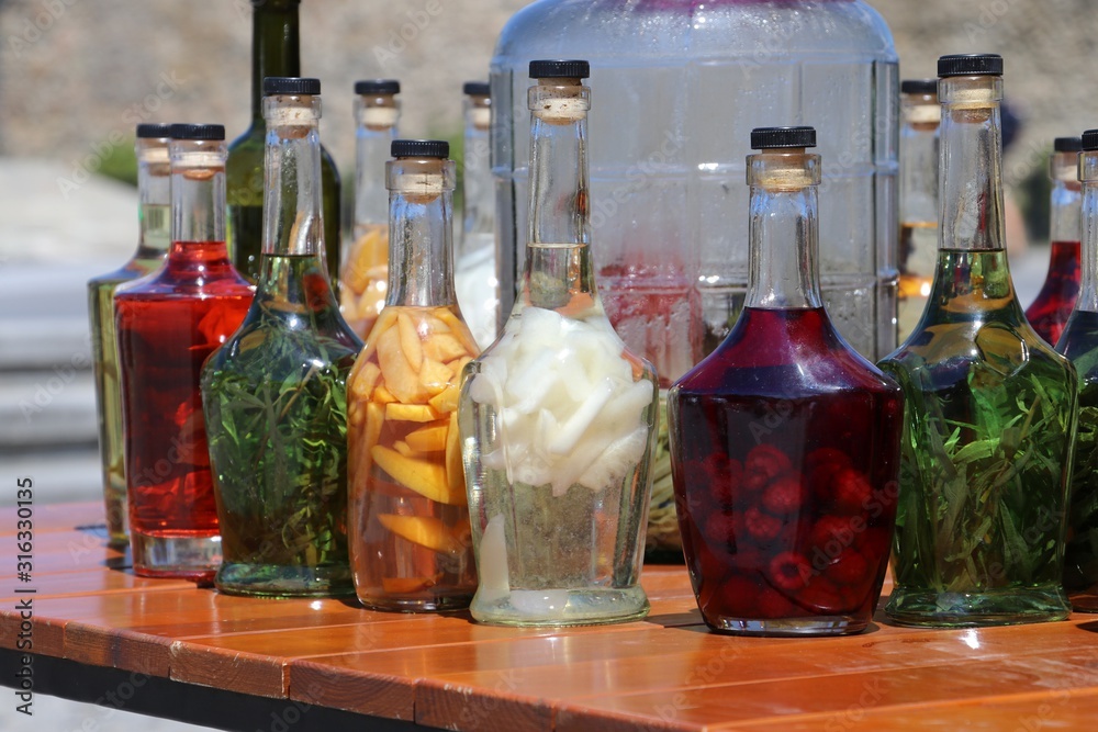 Bottles with alcohols and fruits. Tincture Bottles with alcohols and fruits. Tincture