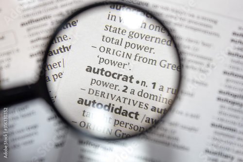 The word of phrase - autocrat - in a dictionary. photo