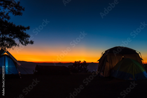 The light of the sunset during the twilight and the tents of tourists who come to admire the beauty of nature.
