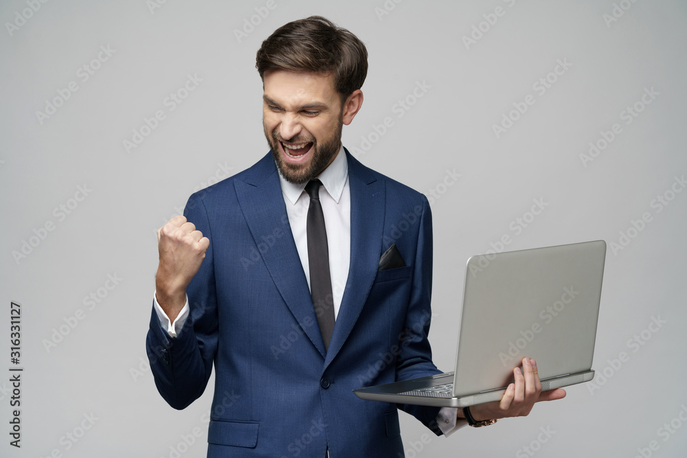 Young handsome businessman Holding a laptop Computer with Blank Screen Young handsome businessman Holding a laptop Computer with Blank Screen