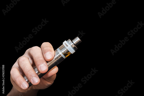 Photography A man's hand holds an electronic cigarette