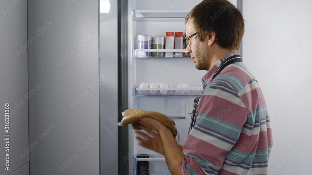 Chef husband puts the dough in the refrigerator. The home kitchen works for the family. Chef husband puts the dough in the refrigerator. The home kitchen works for the family.