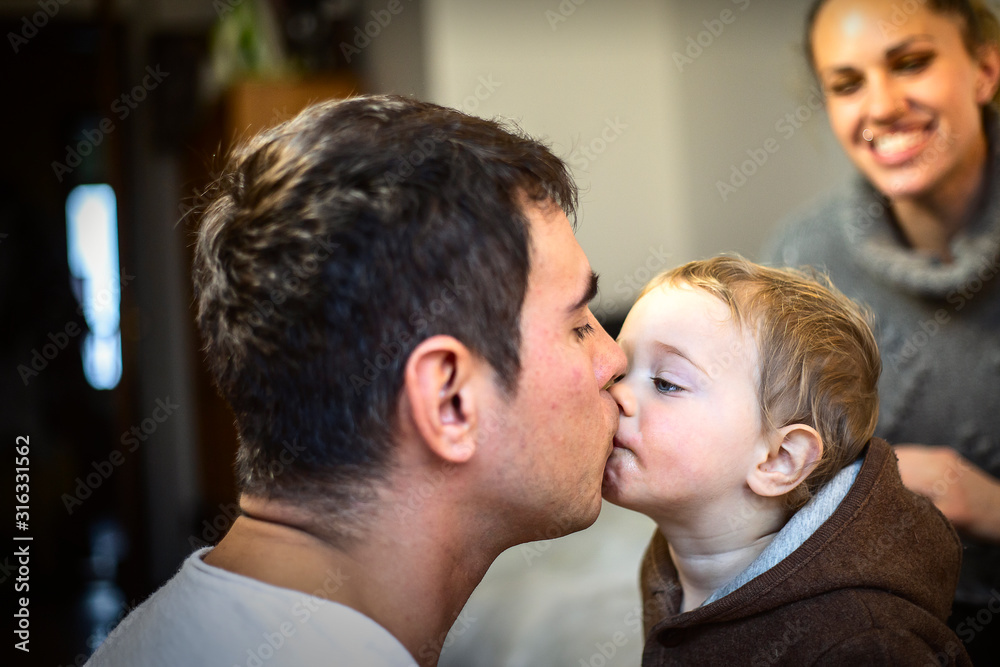 Fototapeta premium Happy young father kissing his sweet adorable baby.