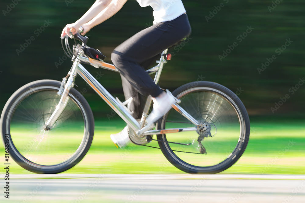 Riding bicycle - blurred motion, fast driving. Riding bicycle - blurred motion, fast driving.