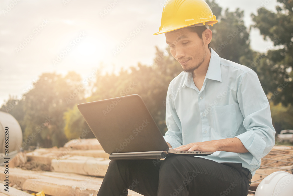 Engineering construction holding computer notebook inspection work at estate building project