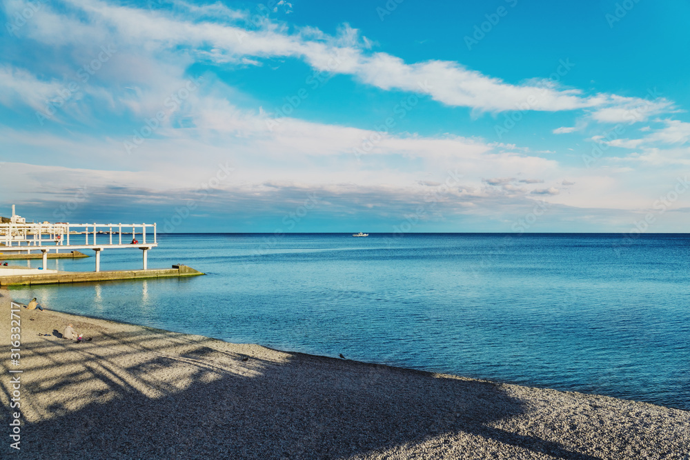 View of the coastline. Massandra beach, Yalta, Crimea. Metal frames shelters from the sun