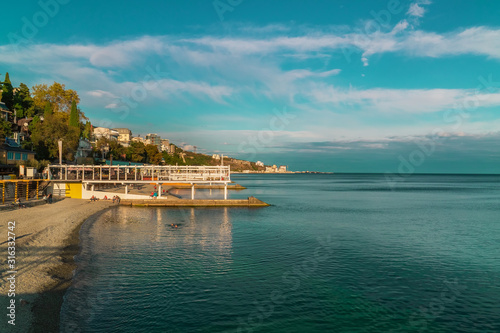 View of the coastline. Massandra beach, Yalta, Crimea. Metal frames shelters from the sun © oksanamedvedeva