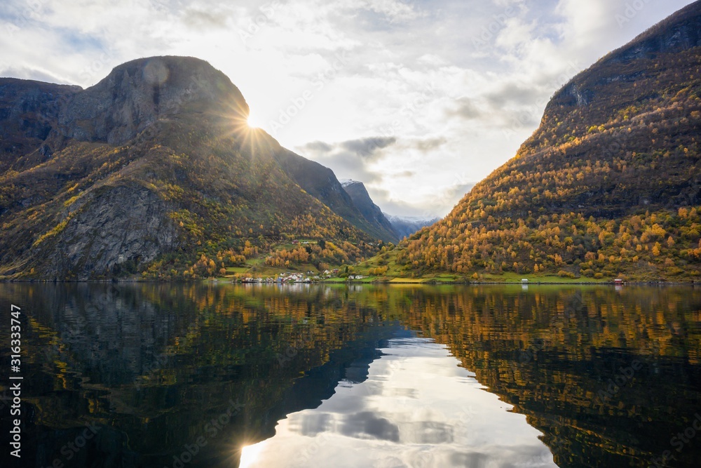The village of Undredal is a small village on the fjord. Aurlandsfjord West coast of Norway, High mountains and villages reflect in the water during autumn season.