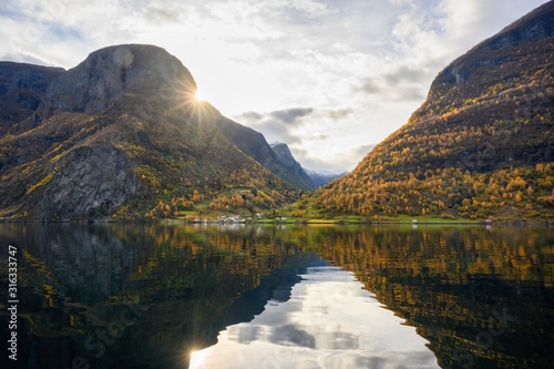 Obraz na płótnie The village of Undredal is a small village on the fjord. Aurlandsfjord West coast of Norway, High mountains and villages reflect in the water during autumn season. w salonie
