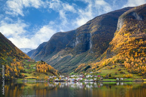 The village of Undredal is a small village on the fjord. Aurlandsfjord West coast of Norway, High mountains and villages reflect in the water during autumn season. photo