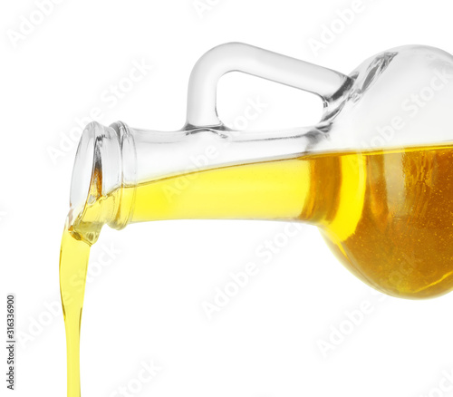Pouring cooking oil from pitcher isolated on white