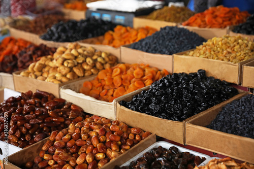 Delicious dried fruits on counter at wholesale market