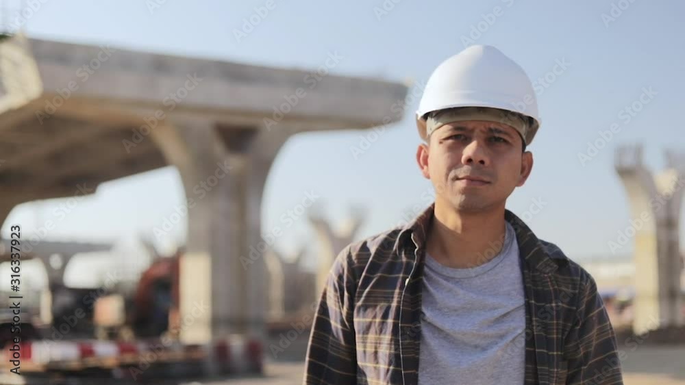 Engineers Construction walking and holds blueprint in construction site. Engineers Construction walking and holds blueprint in construction site.